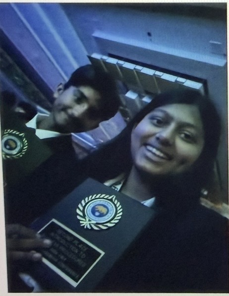 Sufee Kathane with a teammate and an FBLA award plaque