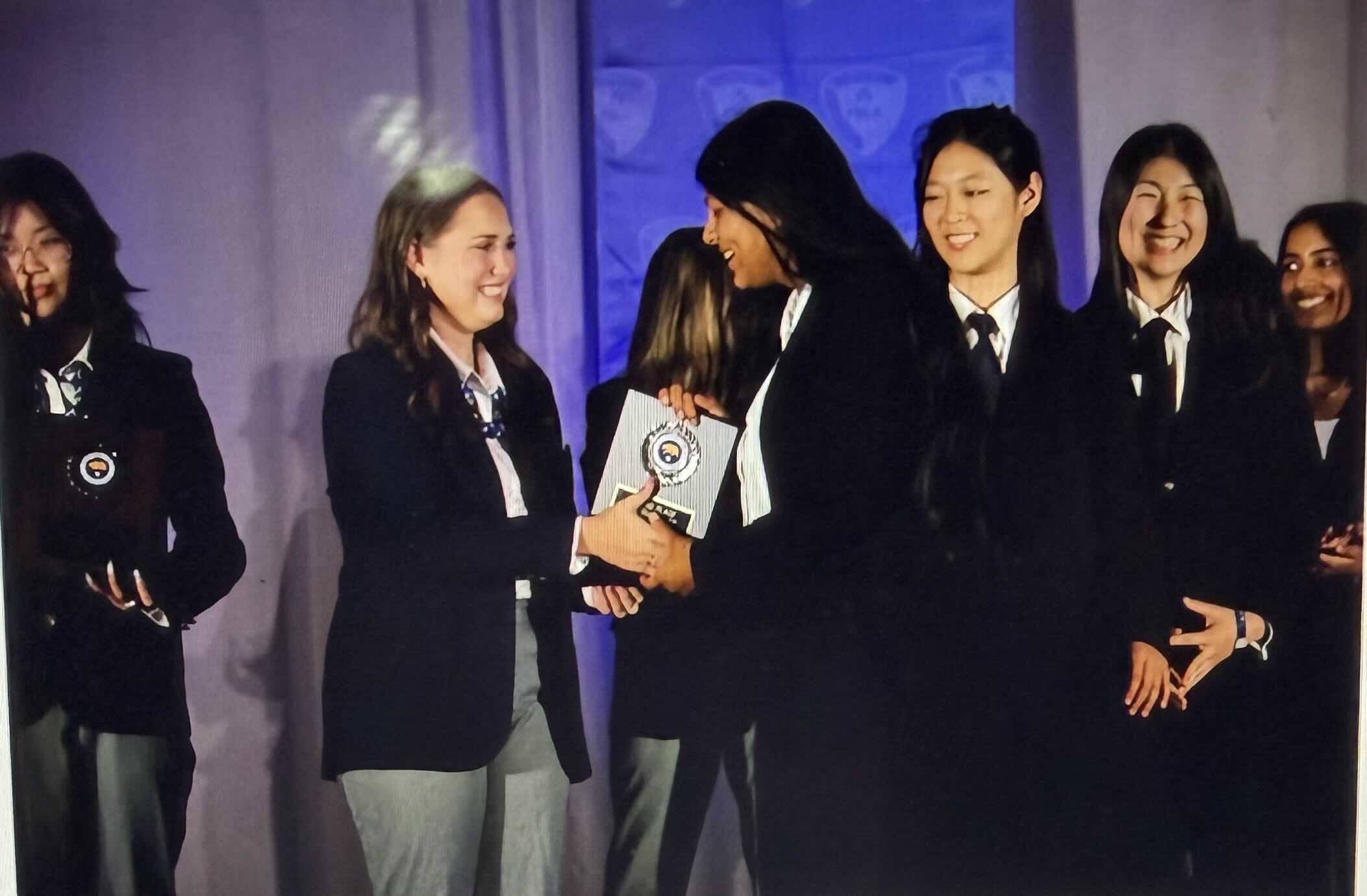 Sufee Kathane on stage receiving an FBLA award
