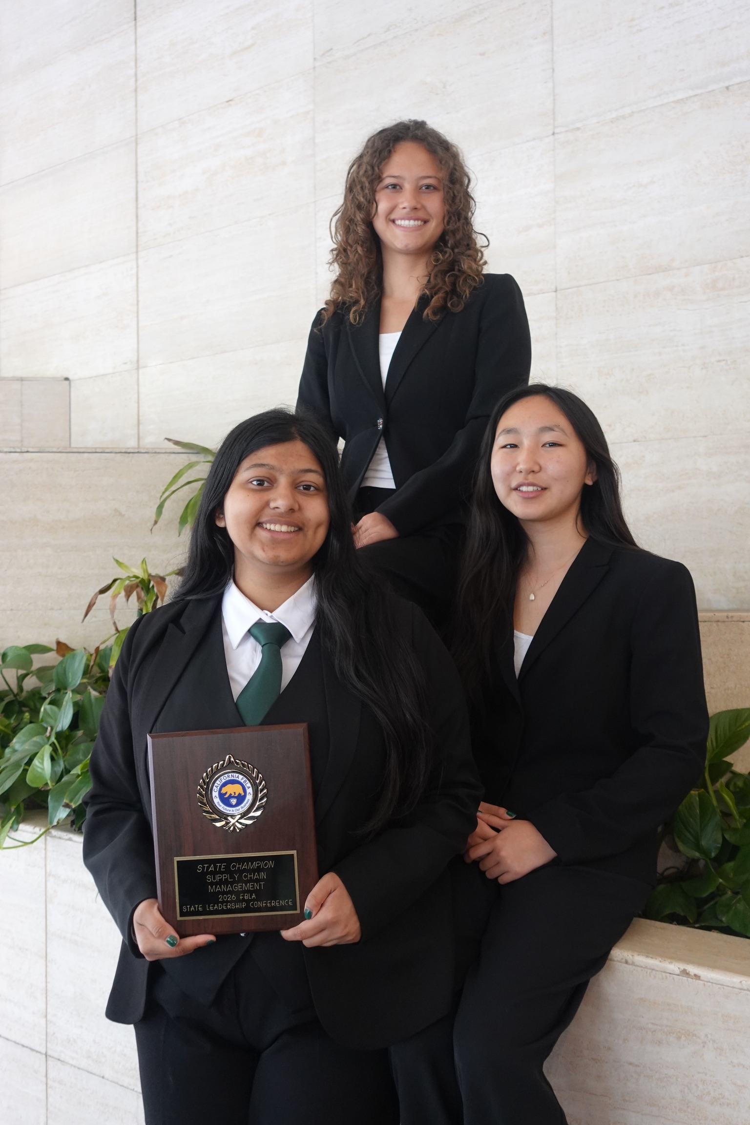 Sufee Kathane and teammates with the FBLA State Champion plaque