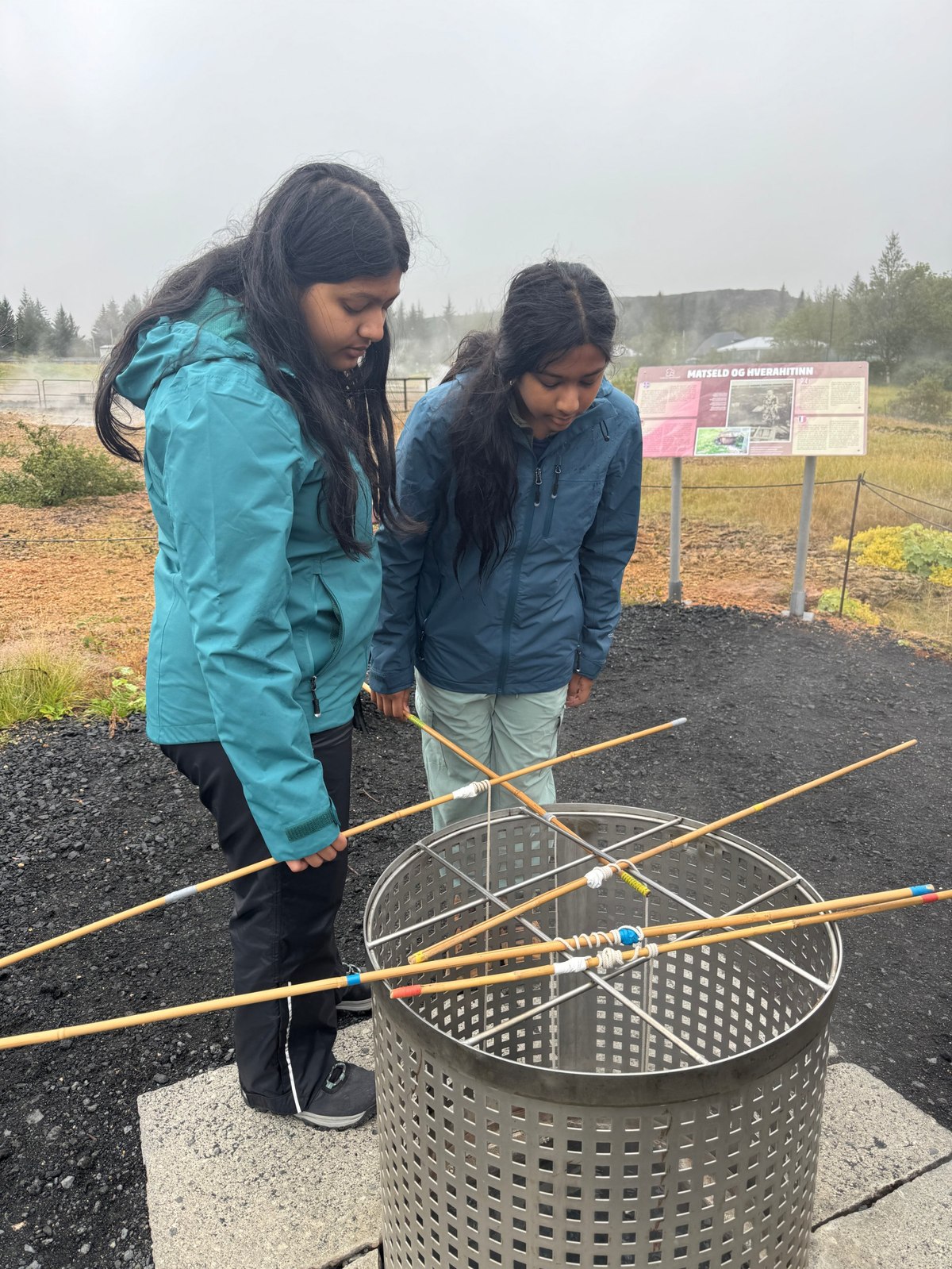 Sufee and her sister by a geothermal baking site near a geyser in Iceland