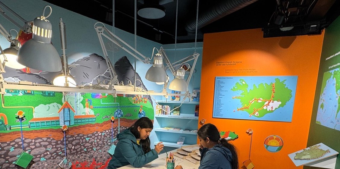 Sufee and her sister at a kids' volcano science exhibit in Iceland
